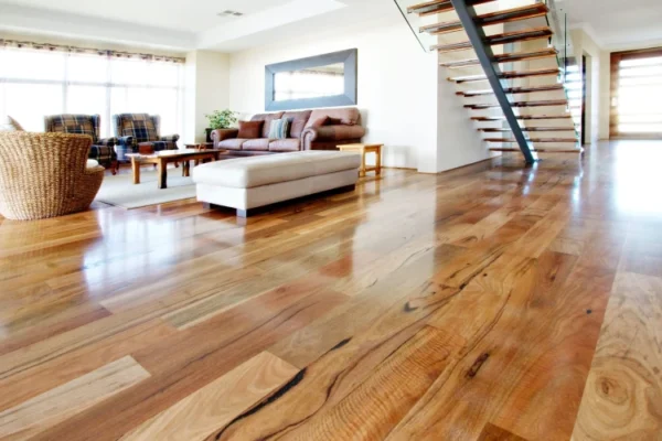 A modern, open-concept living space featuring polished Solid Wood flooring with natural grain patterns. A modern, open-concept living space featuring polished Solid Wood flooring with natural grain patterns.